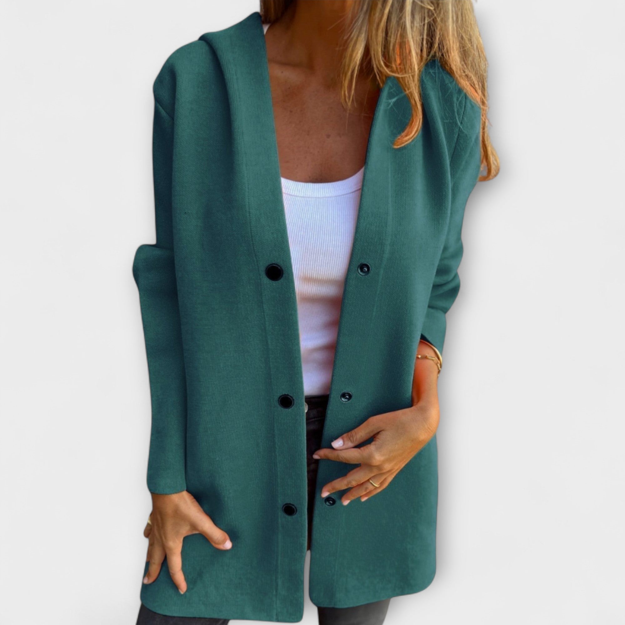 Grüne lange Jacke mit Knopfleiste, Reverskragen und Taschen, offen getragen
